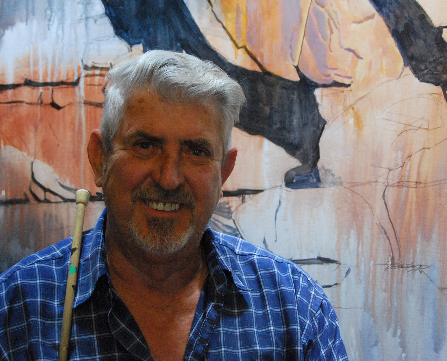Artist Garry Duncan in front of one of his artworks